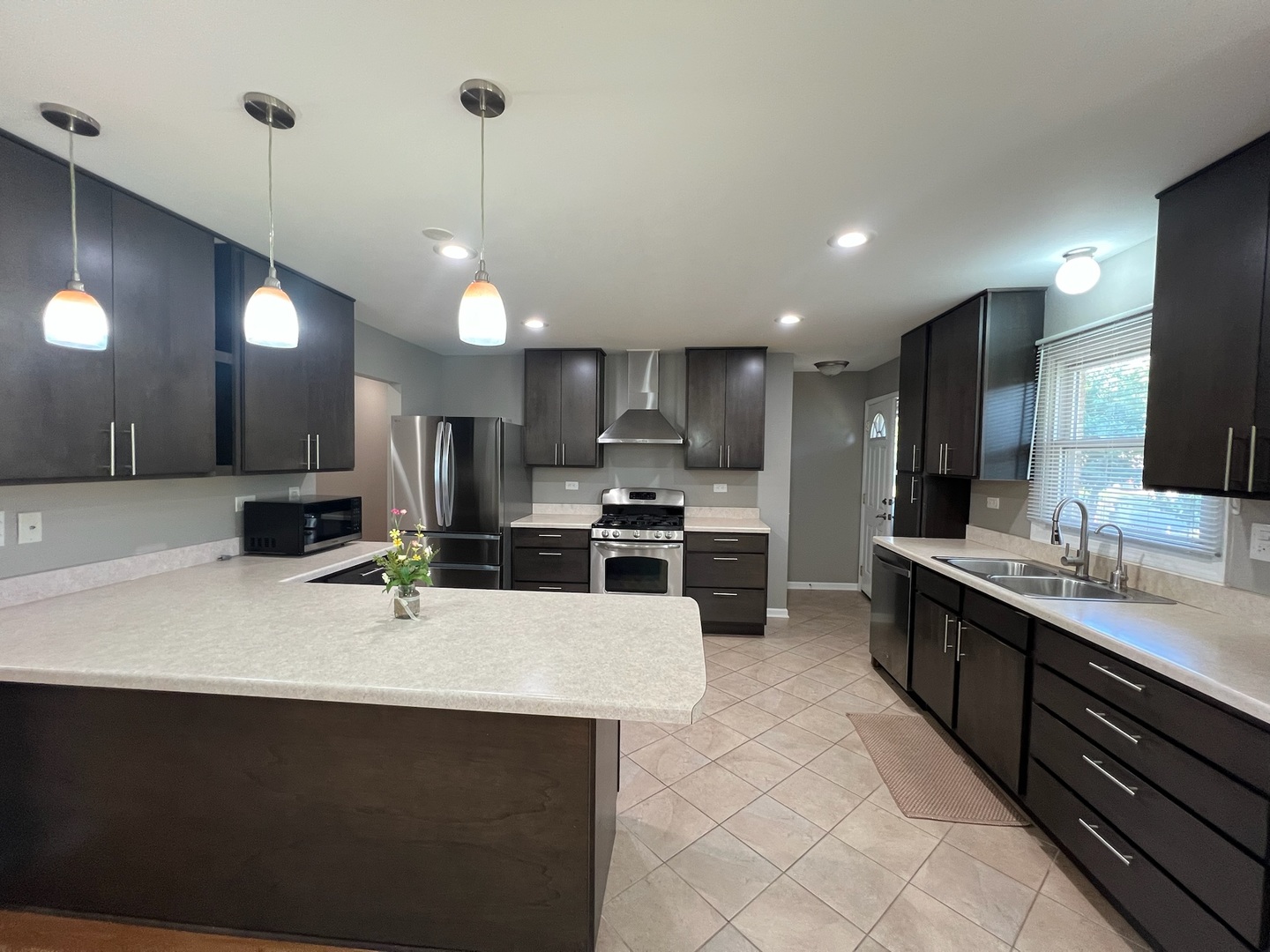 548 Delaware Trail Carol Stream, IL 60188 - Photo 3 of 26 a kitchen with stainless steel appliances a sink a stove a refrigerator and a oven