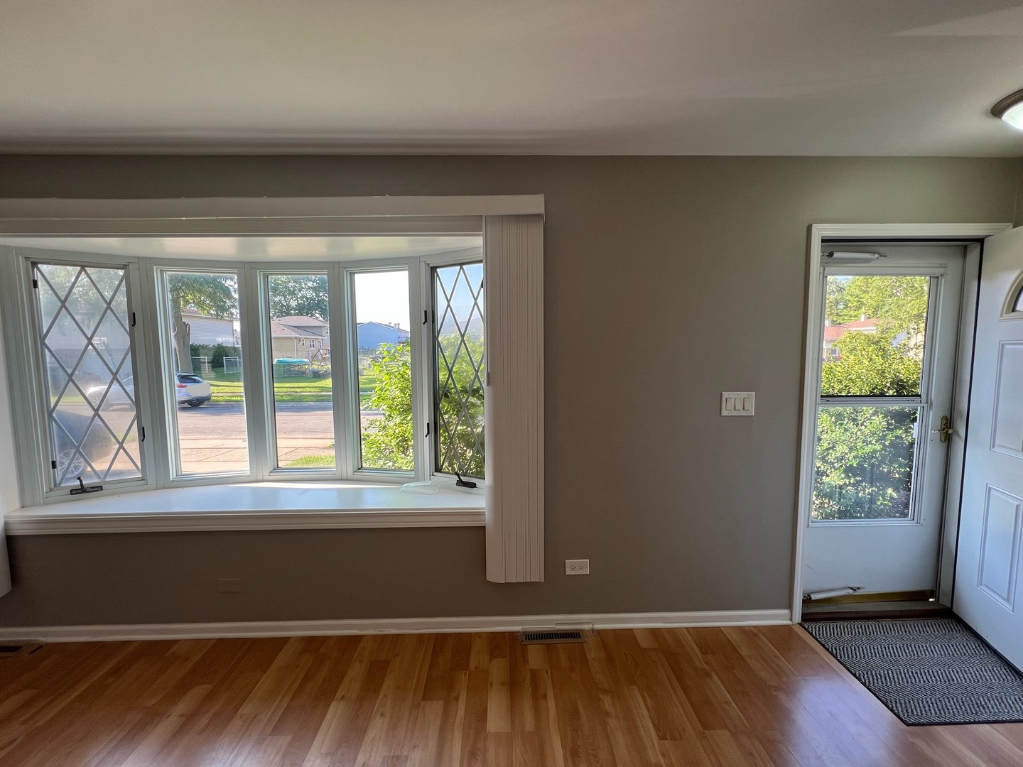 548 Delaware Trail Carol Stream, IL 60188 - Photo 7 of 26 an empty room with wooden floor and windows