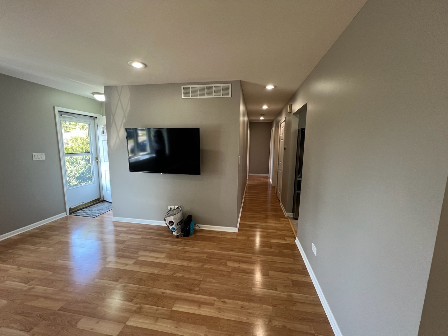 548 Delaware Trail Carol Stream, IL 60188 - Photo 8 of 26 a view of a livingroom with wooden floor and a flat screen tv