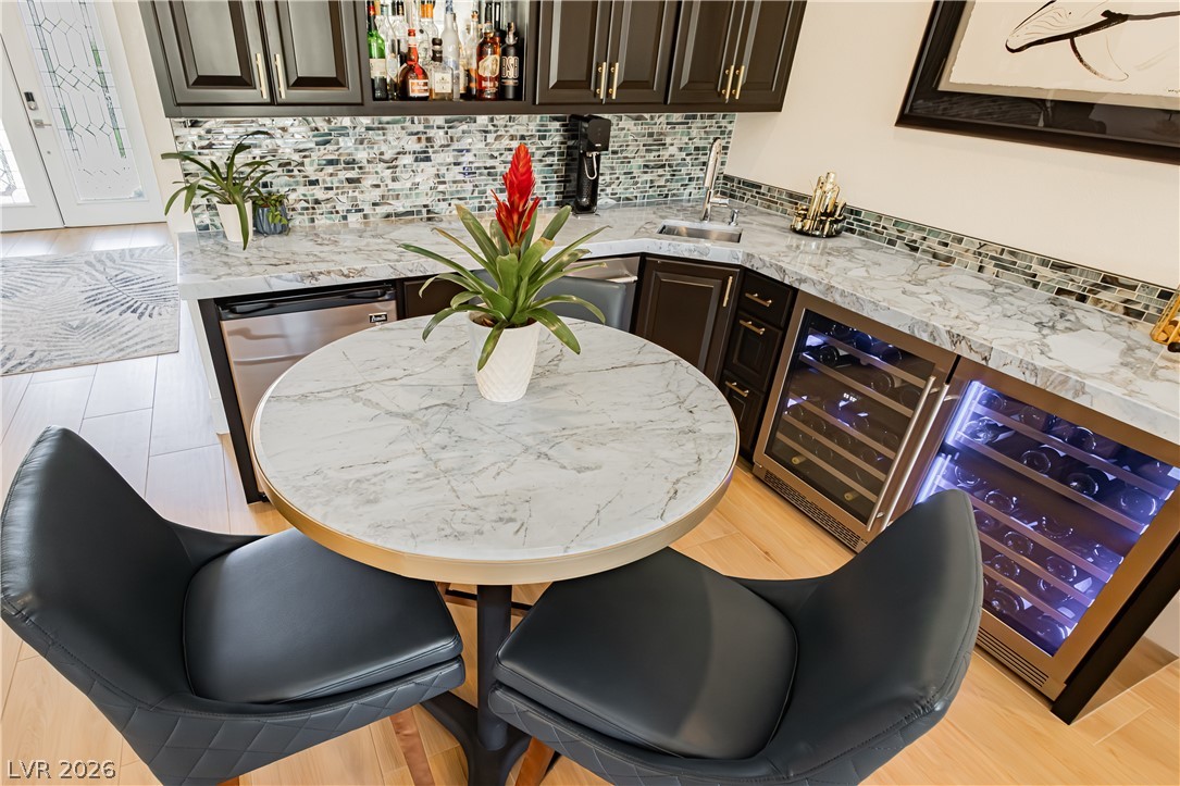 2256 Dogwood Ranch Avenue Henderson, NV 89052 - Photo 27 of 51 Marble countertops and a tile backsplash define this elegant home bar, complete with integrated wine storage.