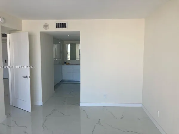 a bathroom with a shower and a glass door