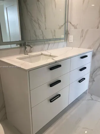 a white toilet sitting next to a shower