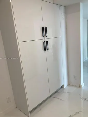 a view of walk in closet with clothes