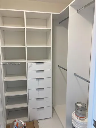 a view of bathroom and a walk in closet