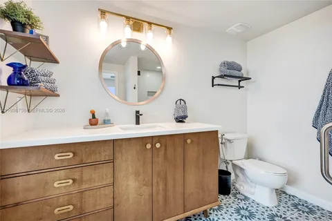 a bathroom with a toilet a sink and mirror