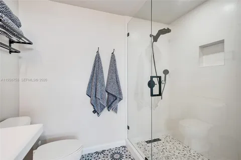 a bathroom with a shower toilet and sink