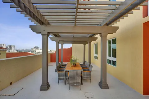 a dining room with furniture and a floor to ceiling window