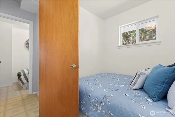 a bedroom with a bed and a window