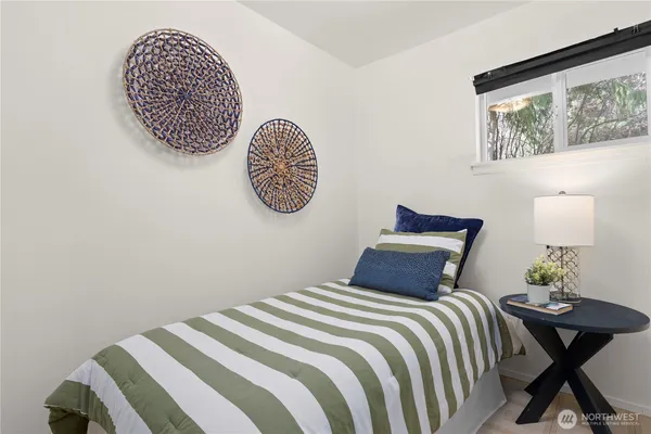 a bedroom with a bed and a painting on the wall