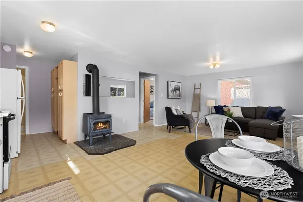 a living room with furniture a dining table and a fireplace