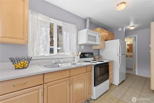 a kitchen with a sink stove and refrigerator