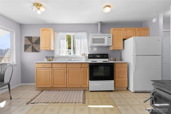 a kitchen with a white cabinets and white appliances