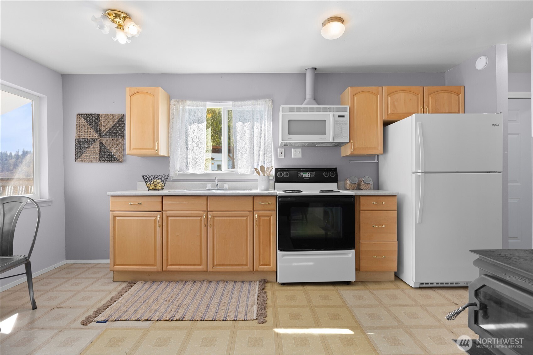 39201 Orville Road East Eatonville, WA 98328 - Photo 9 of 30 a kitchen with a white cabinets and white appliances