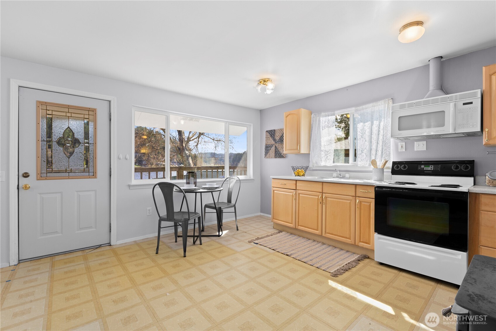 39201 Orville Road East Eatonville, WA 98328 - Photo 10 of 30 a kitchen with a stove a sink and a refrigerator
