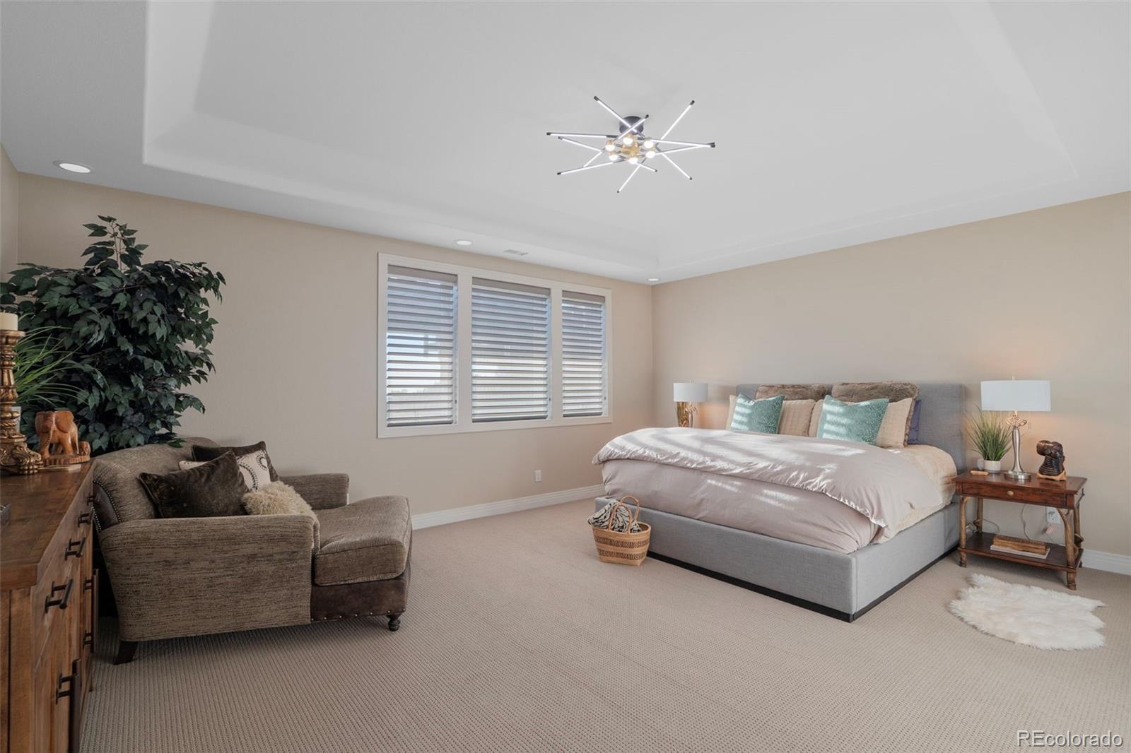 730 Genesee Mountain Road Golden, CO 80401 - Photo 38 of 50 a spacious bedroom with a bed and a couch