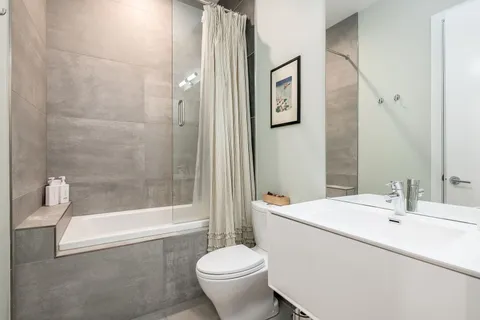 a bathroom with a sink toilet and shower