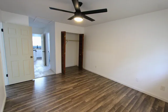 a view of an empty room with wooden floor