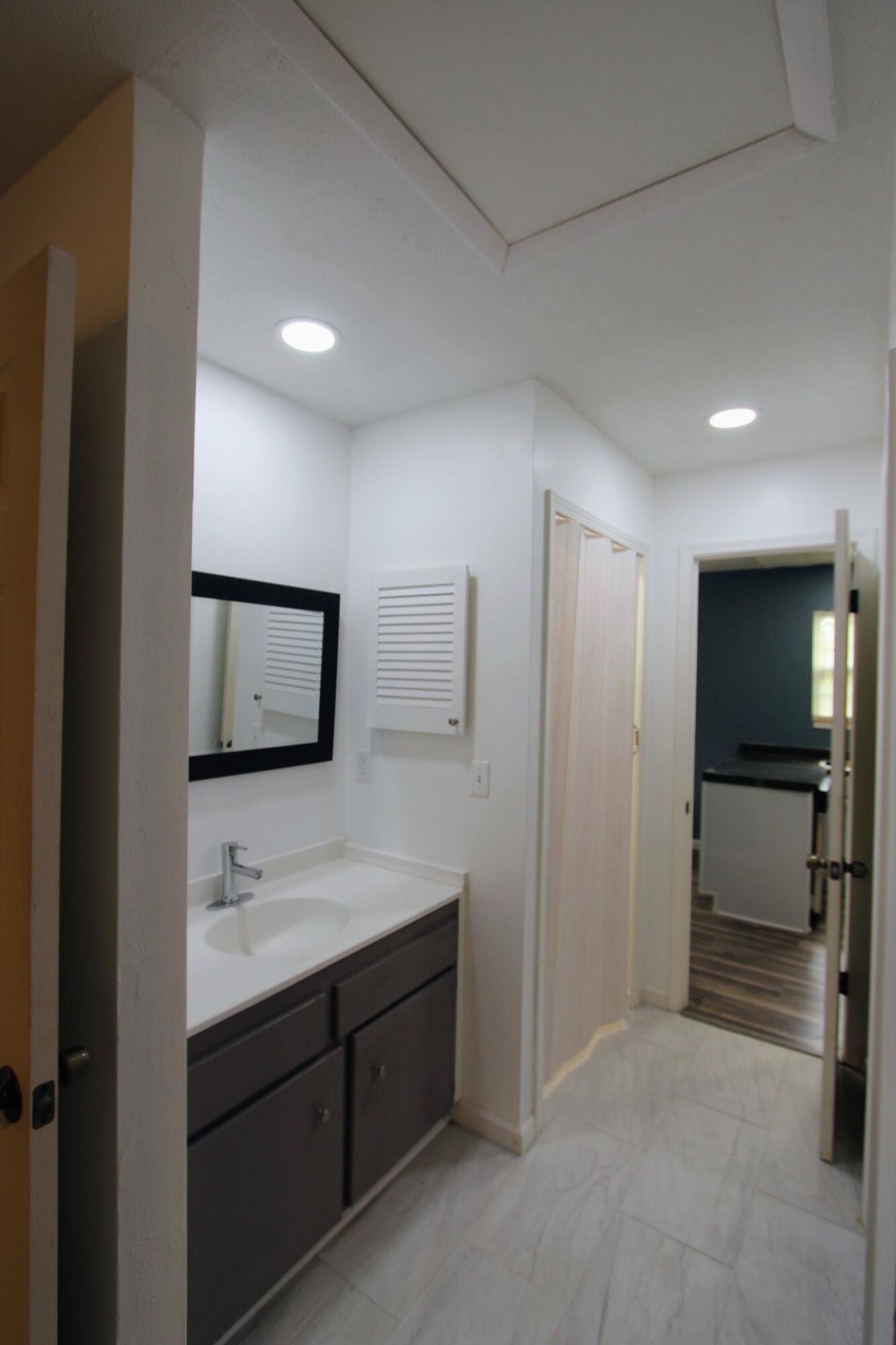 8250 Kause Road Pensacola, FL 32506 - Photo 16 of 28 a bathroom with a sink a toilet and mirror