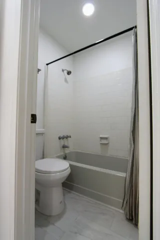 a bathroom with a shower and a toilet