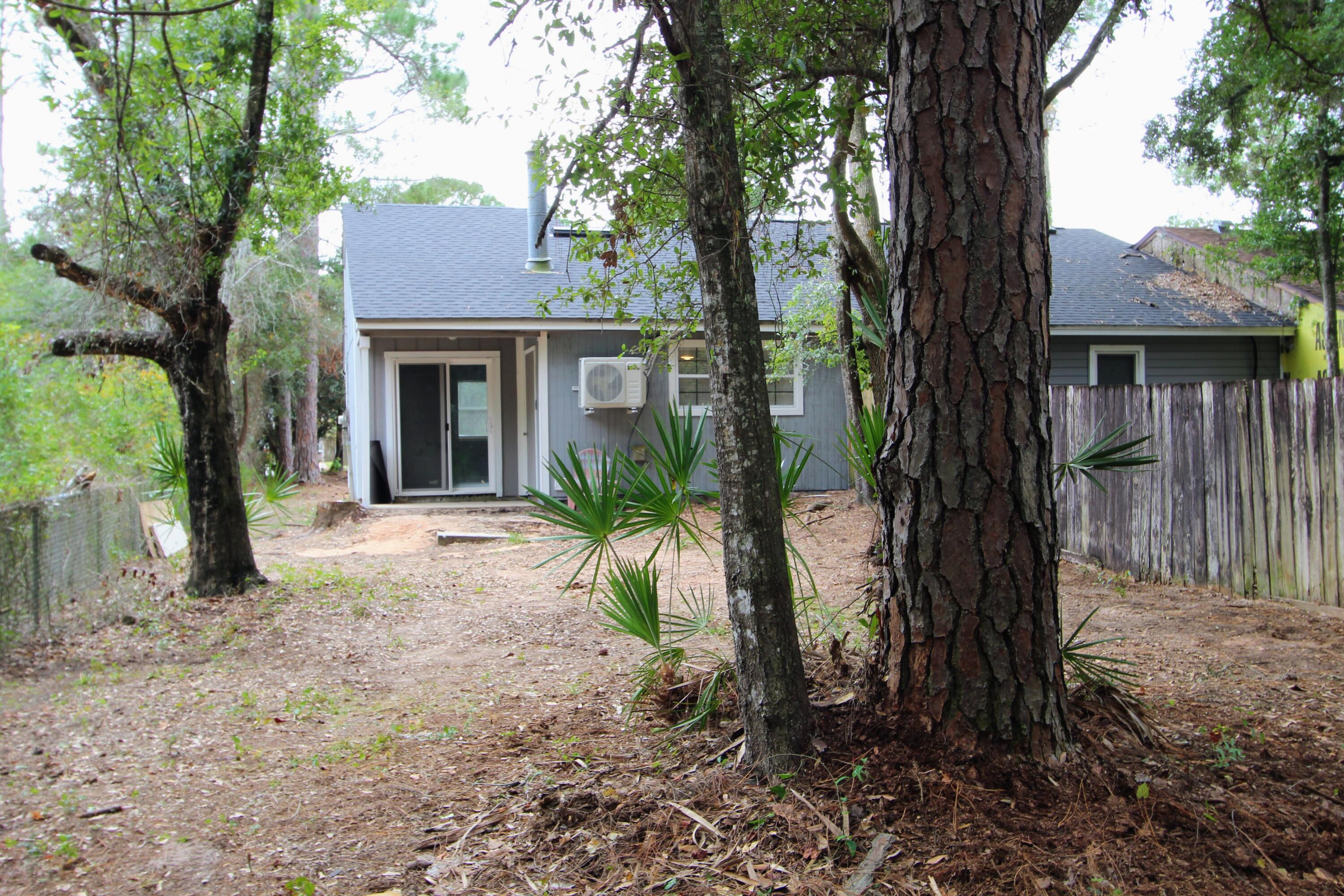 8250 Kause Road Pensacola, FL 32506 - Photo 23 of 28 a view of a house with a tree in front of it