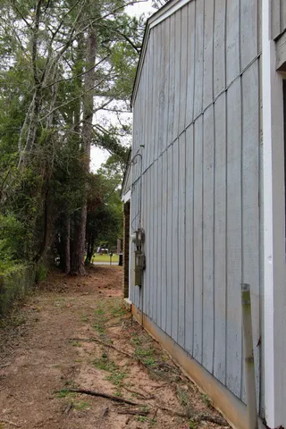 a view of a backyard with wooden fence