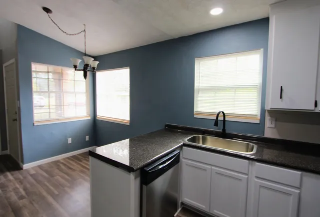 a kitchen with a sink and window