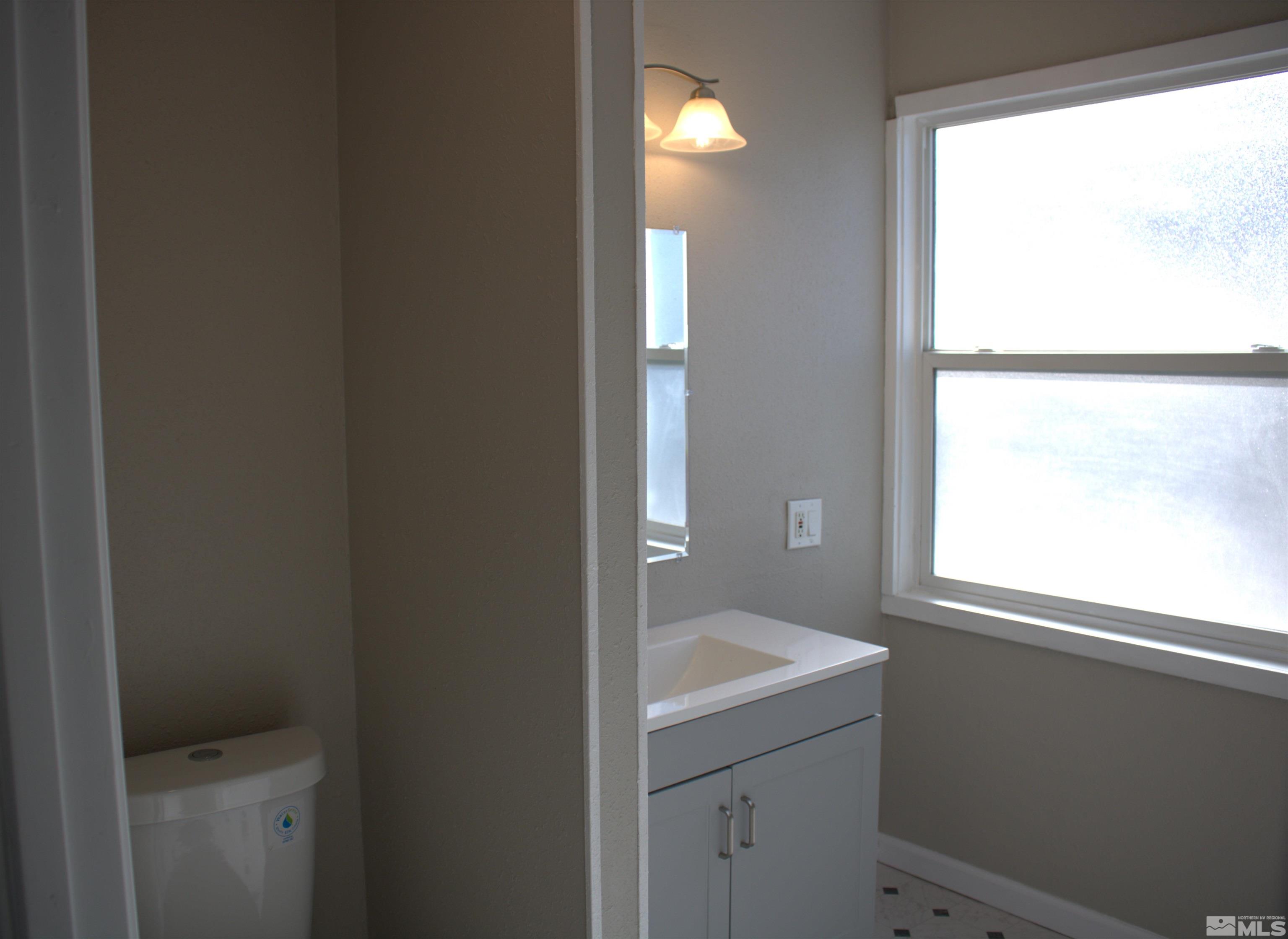 16190 Rhyolite Circle Reno, NV 89521 - Photo 20 of 28 a bathroom with a sink toilet and window