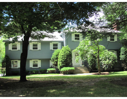 1843 Central Avenue Needham, MA 02492 - Photo 1 of 1 a front view of a house with a garden