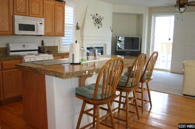 10580 Twin Bridges Way Reno, NV 89521 - Photo 3 of 9 a view of a dining room with furniture and a fireplace