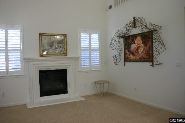 10580 Twin Bridges Way Reno, NV 89521 - Photo 5 of 9 an empty room with windows and fireplace