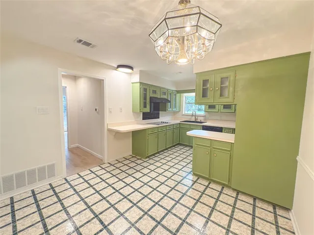 a kitchen with a sink cabinets and window