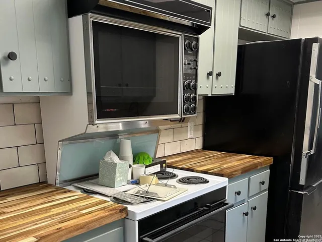a kitchen with a sink and refrigerator