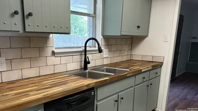 a kitchen with granite countertop a sink and a stove