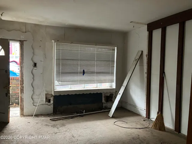 a room with table and white walls