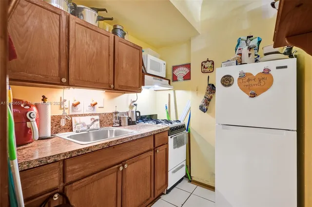 a front view of a multi story building with yard