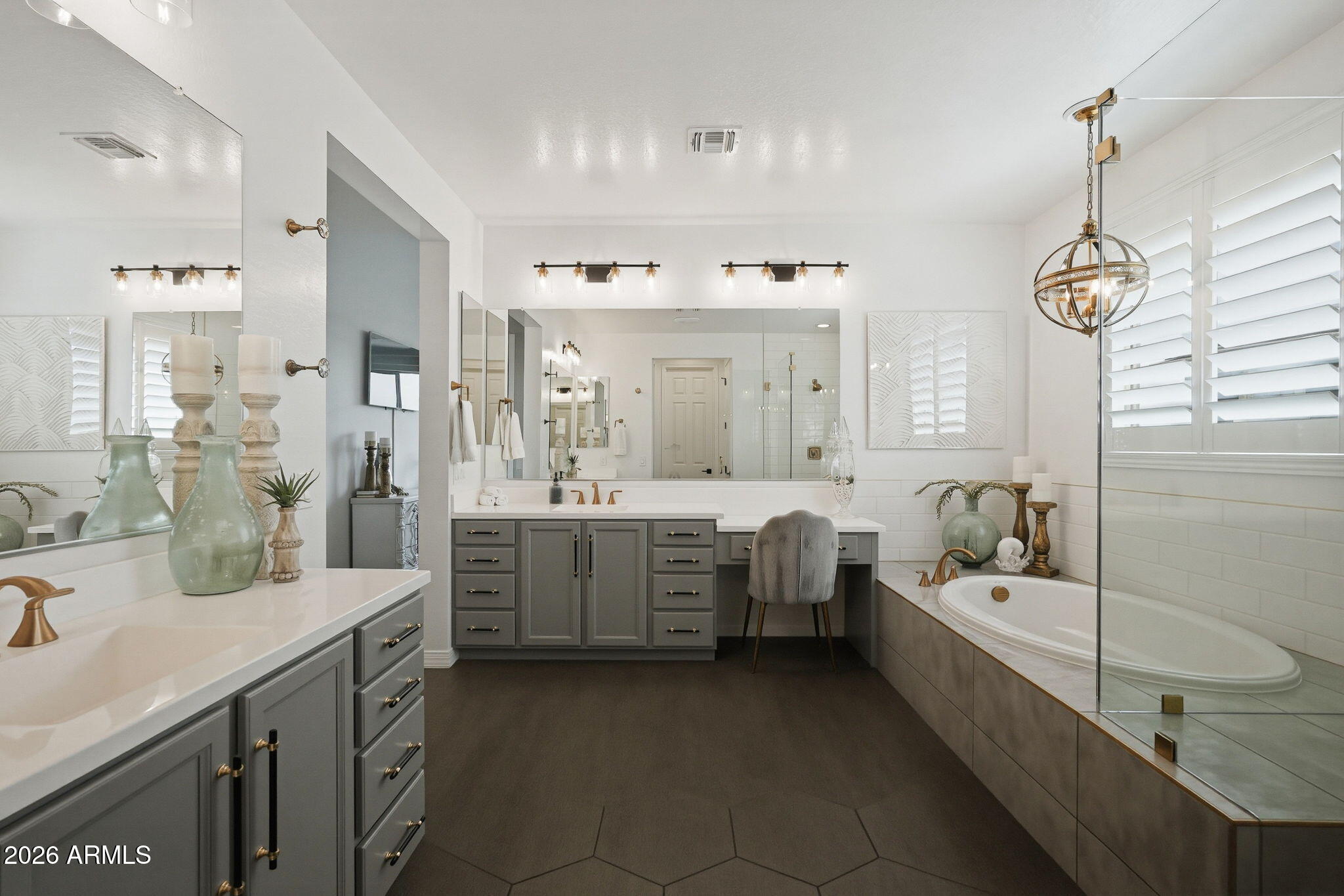 22607 East Russet Road Queen Creek, AZ 85142 - Photo 28 of 64 a bathroom with double vanity sinks a mirror and a bathtub