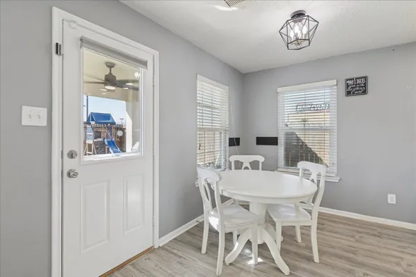 a view of a dining room with furniture window and wooden floor