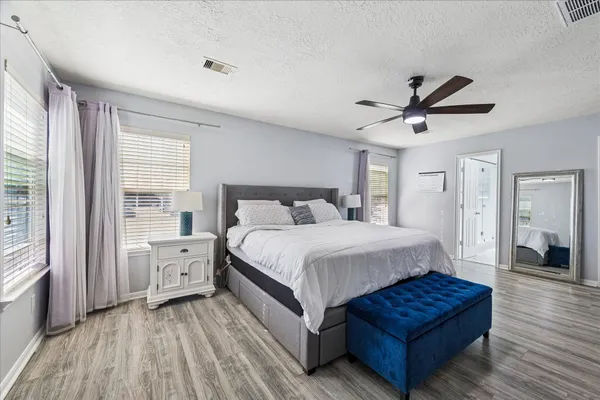 a bedroom with a bed and a large window