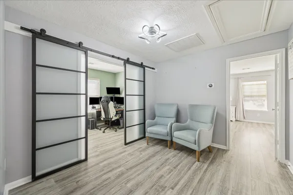 a living room with furniture and a walk in closet