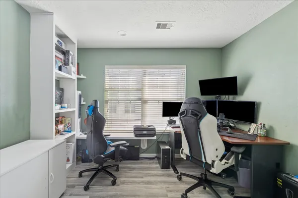 a view of a workspace with furniture and a window