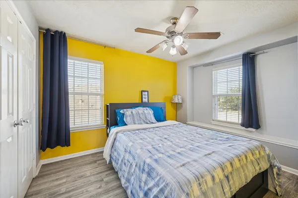 a bedroom with a bed and a chandelier