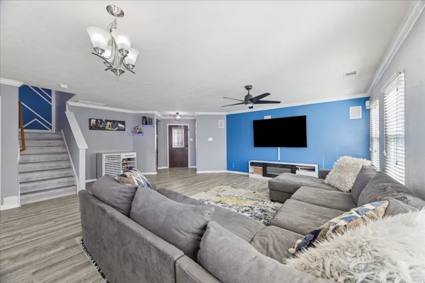 a living room with furniture and a flat screen tv