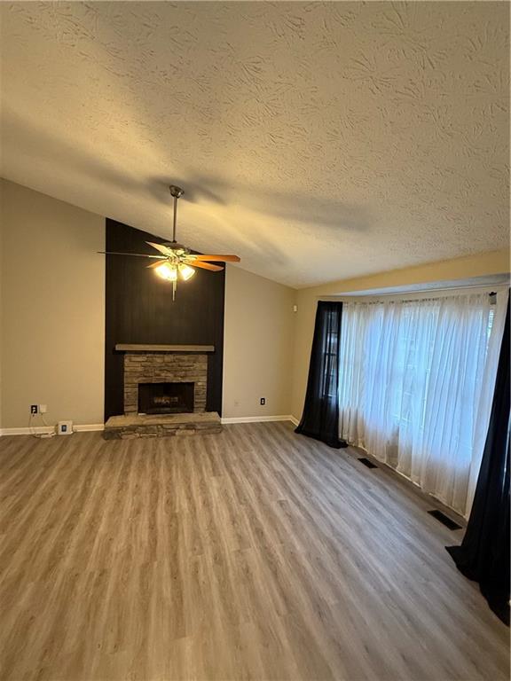 607 Senator Road Douglasville, GA 30134 - Photo 2 of 16 a view of an empty room with wooden floor fireplace and a window