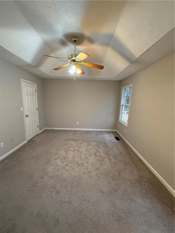 607 Senator Road Douglasville, GA 30134 - Photo 7 of 16 en empty room with windows and ceiling fan