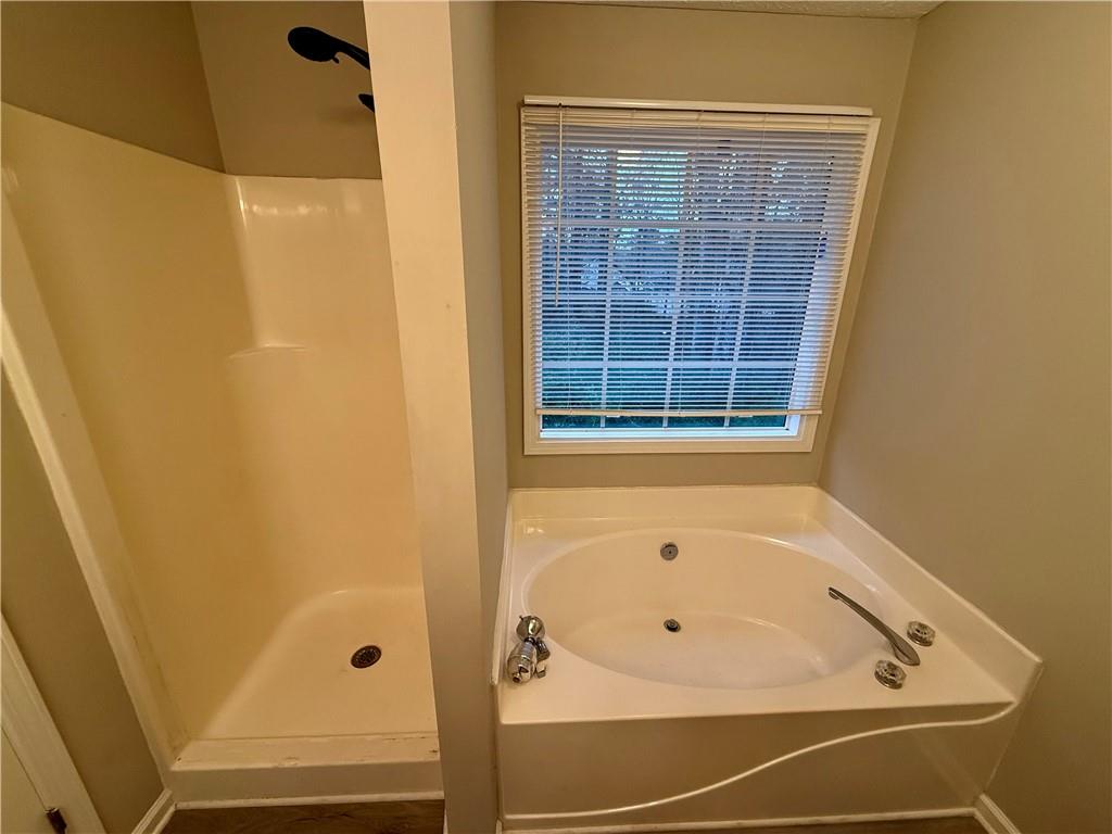 607 Senator Road Douglasville, GA 30134 - Photo 9 of 16 a bathroom with a bathtub and shower