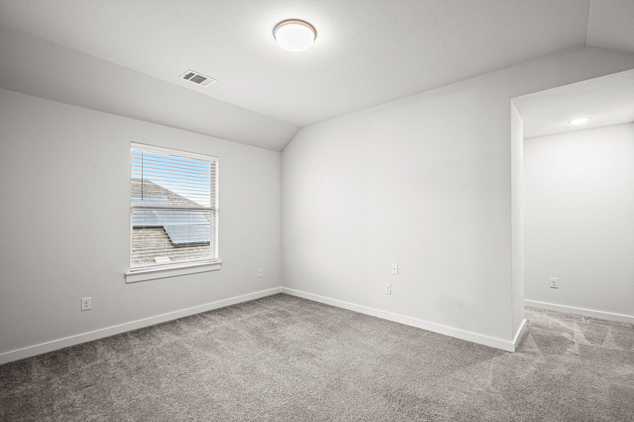 841 Spinnaker Loop Kyle, TX 78640 - Photo 33 of 40 Spare room featuring vaulted ceiling and light carpet