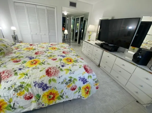 a bedroom with a bed and flat screen tv