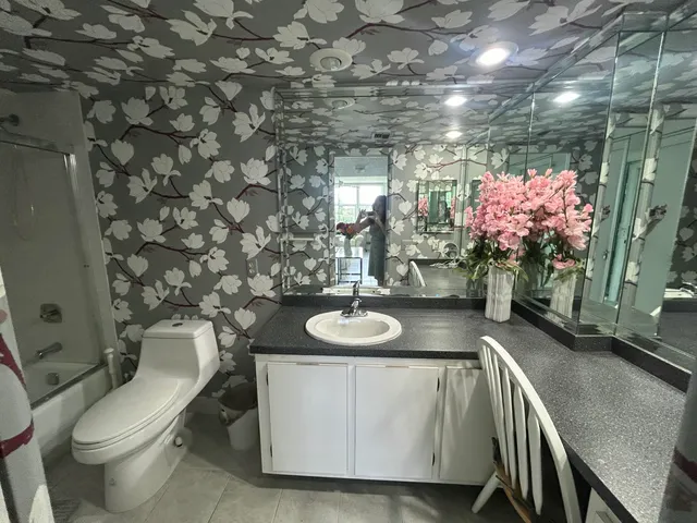 a bathroom with a sink a toilet and mirror