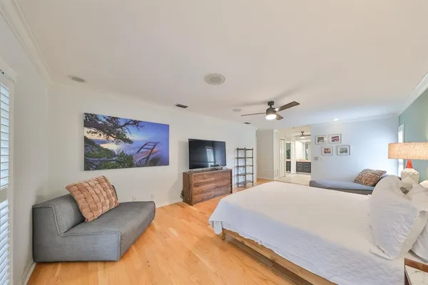 a bedroom with a bed and a dresser with mirror