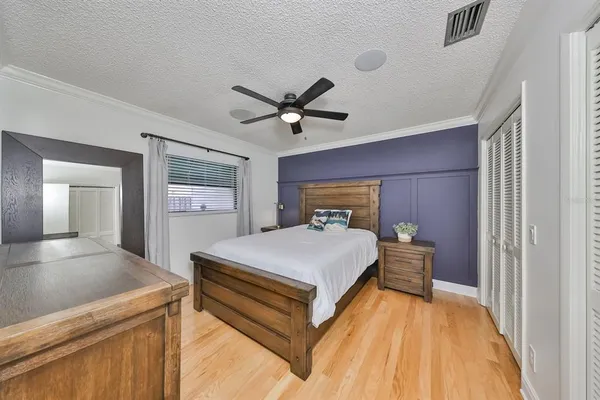 a bedroom with a large bed and a chandelier